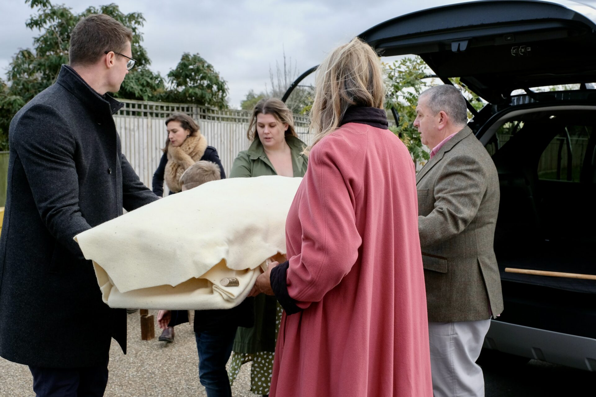 Placing shrouded person in car
