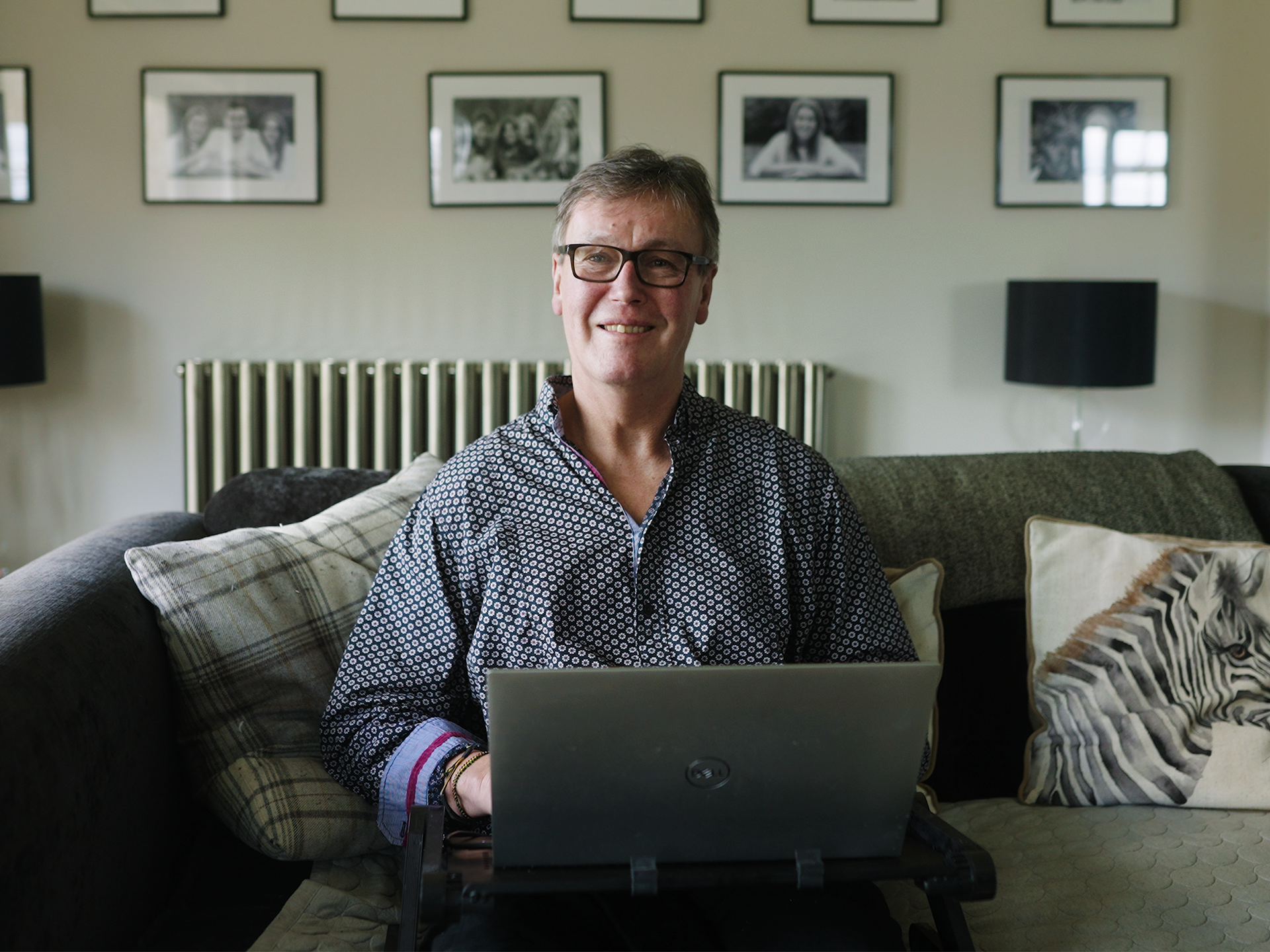 Paul smiling at laptop