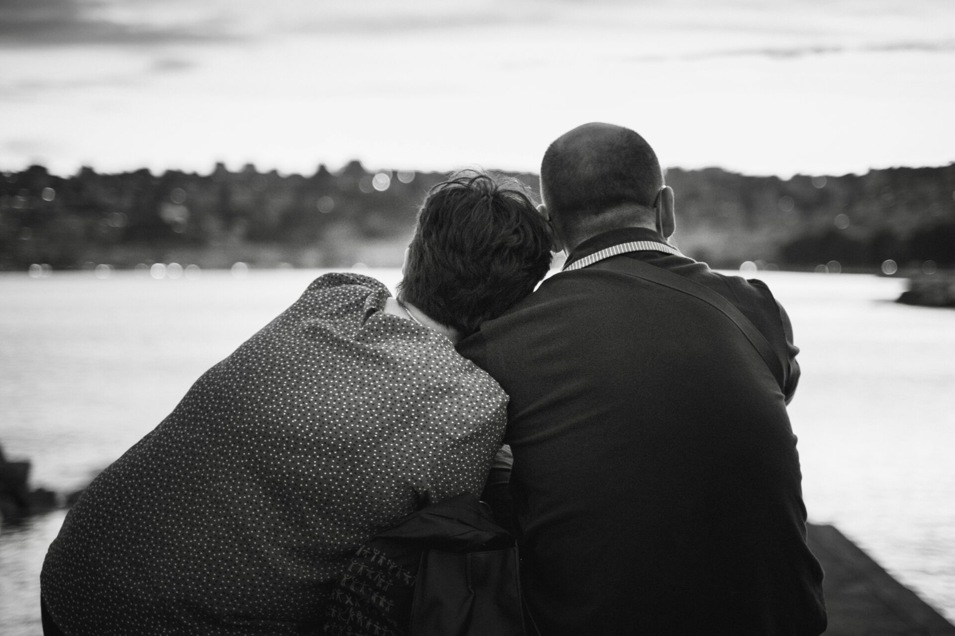 Two people looking out at water